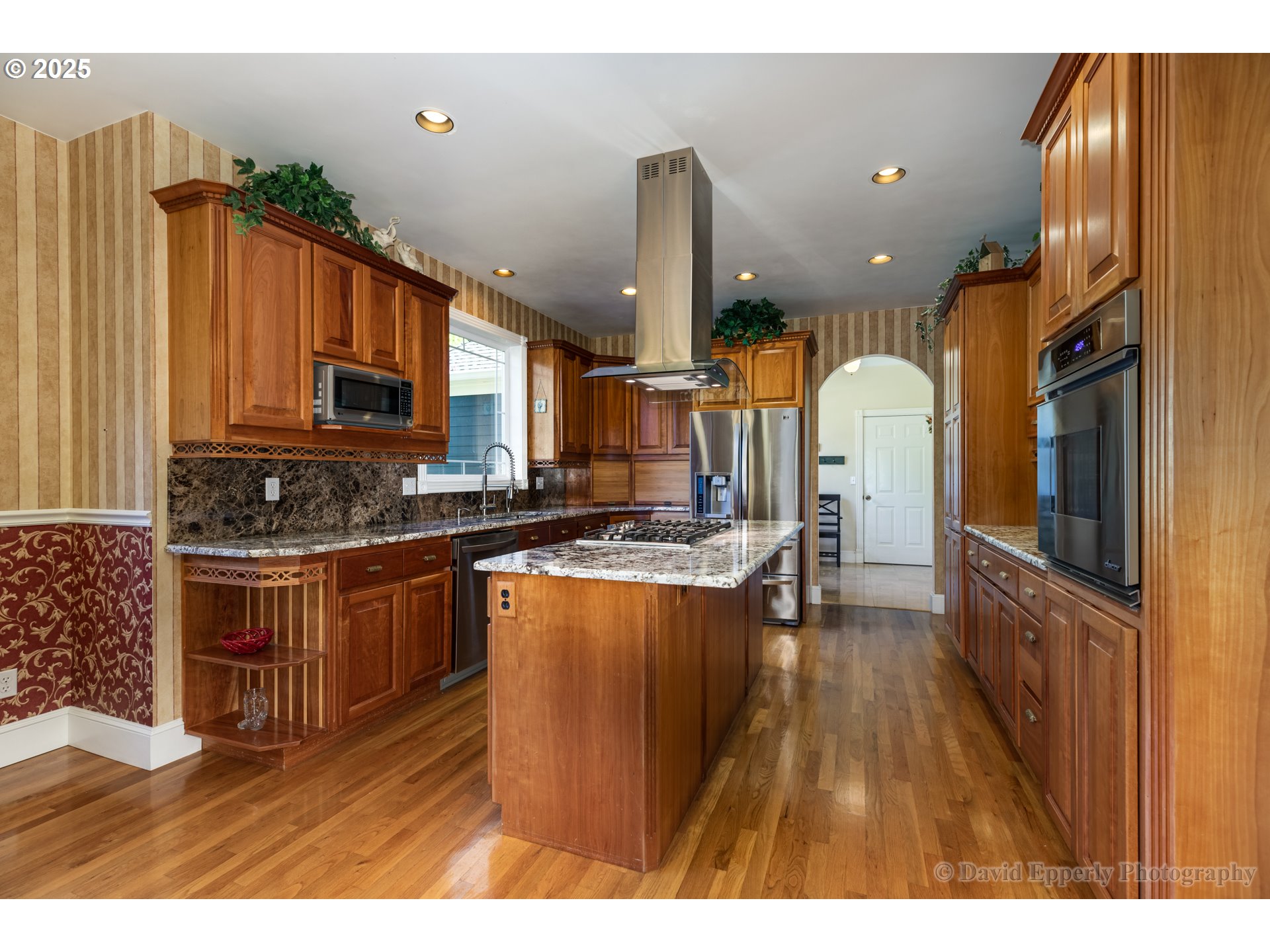 60750 Robinette Road St. Helens, OR 97051 - Photo 11 of 46 a kitchen with stainless steel appliances granite countertop a refrigerator a oven a sink dishwasher and white cabinets with wooden floor
