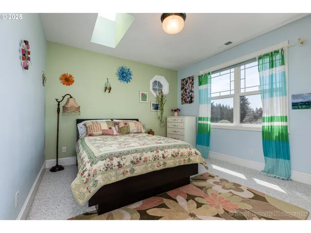 a bedroom with a bed and a large window