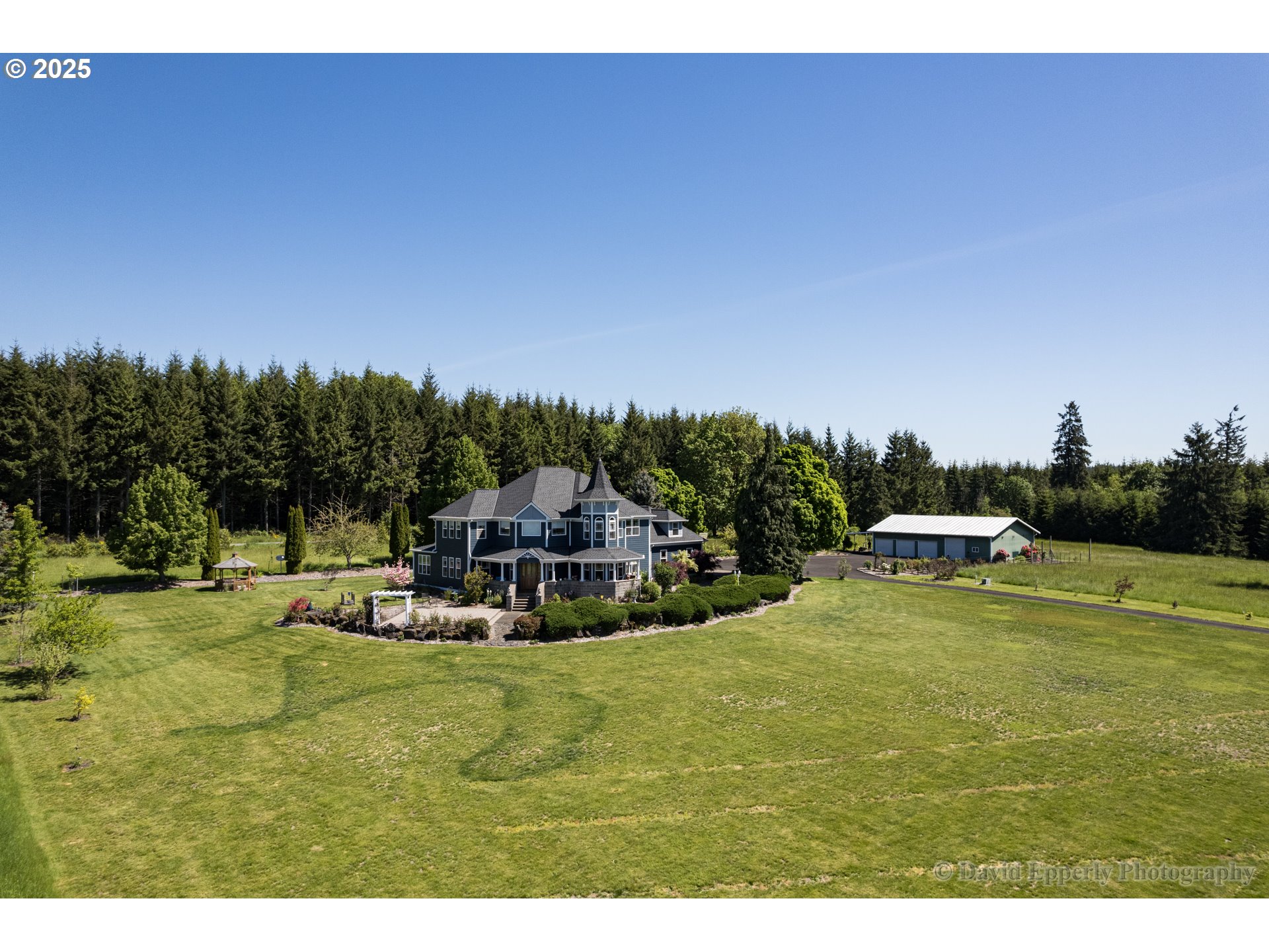 60750 Robinette Road St. Helens, OR 97051 - Photo 2 of 46 a view of a swimming pool with lawn chairs and couches