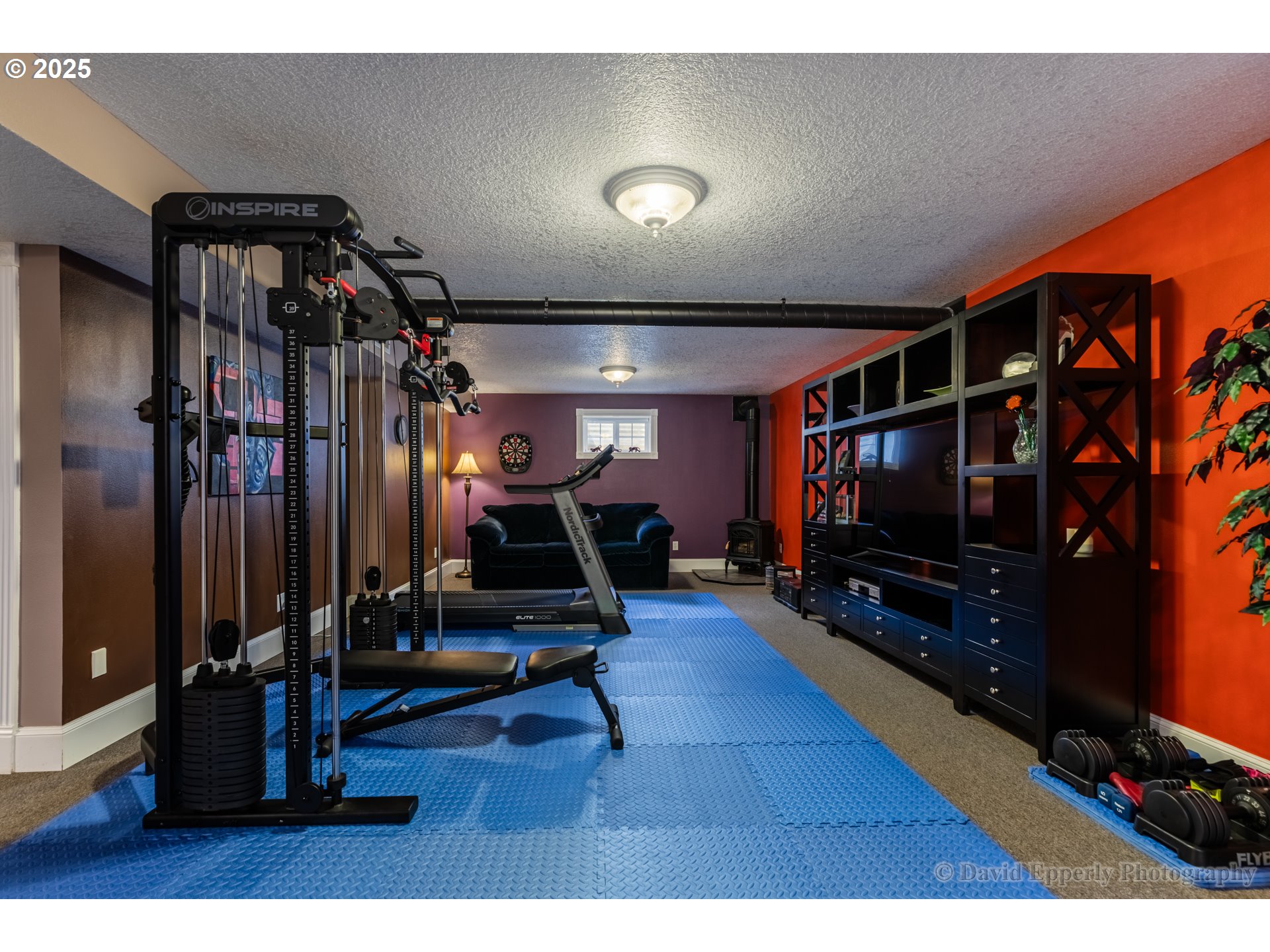 60750 Robinette Road St. Helens, OR 97051 - Photo 25 of 46 a living room with gym equipment and a flat screen tv