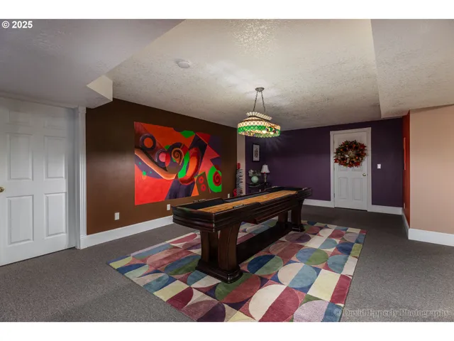 a living room with furniture and painting on the wall