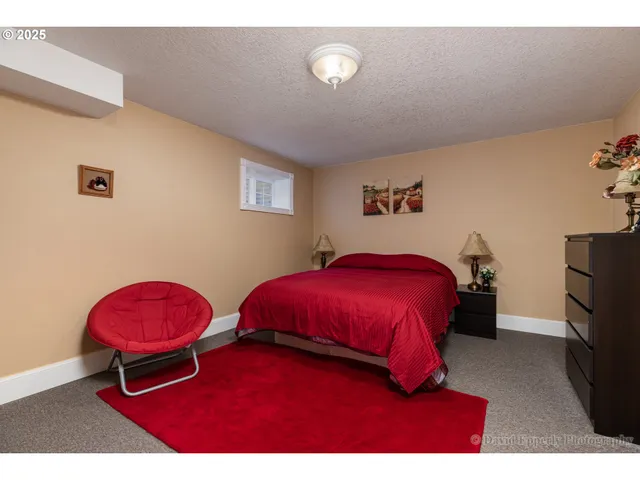 a bedroom with a bed and a chair