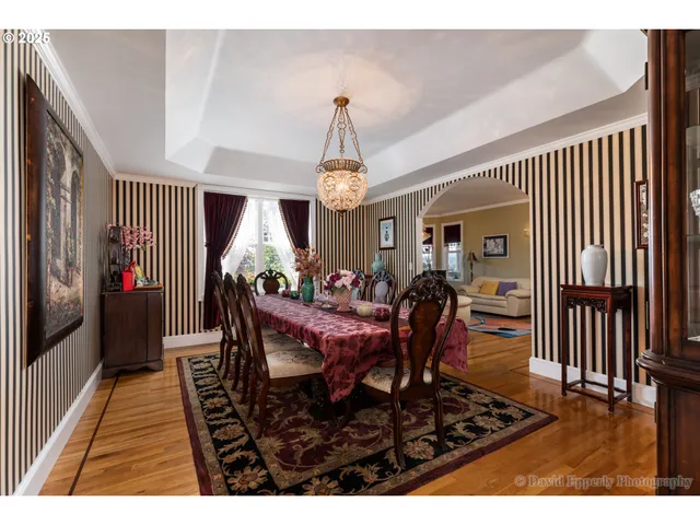 a dining room with furniture window and wooden floor