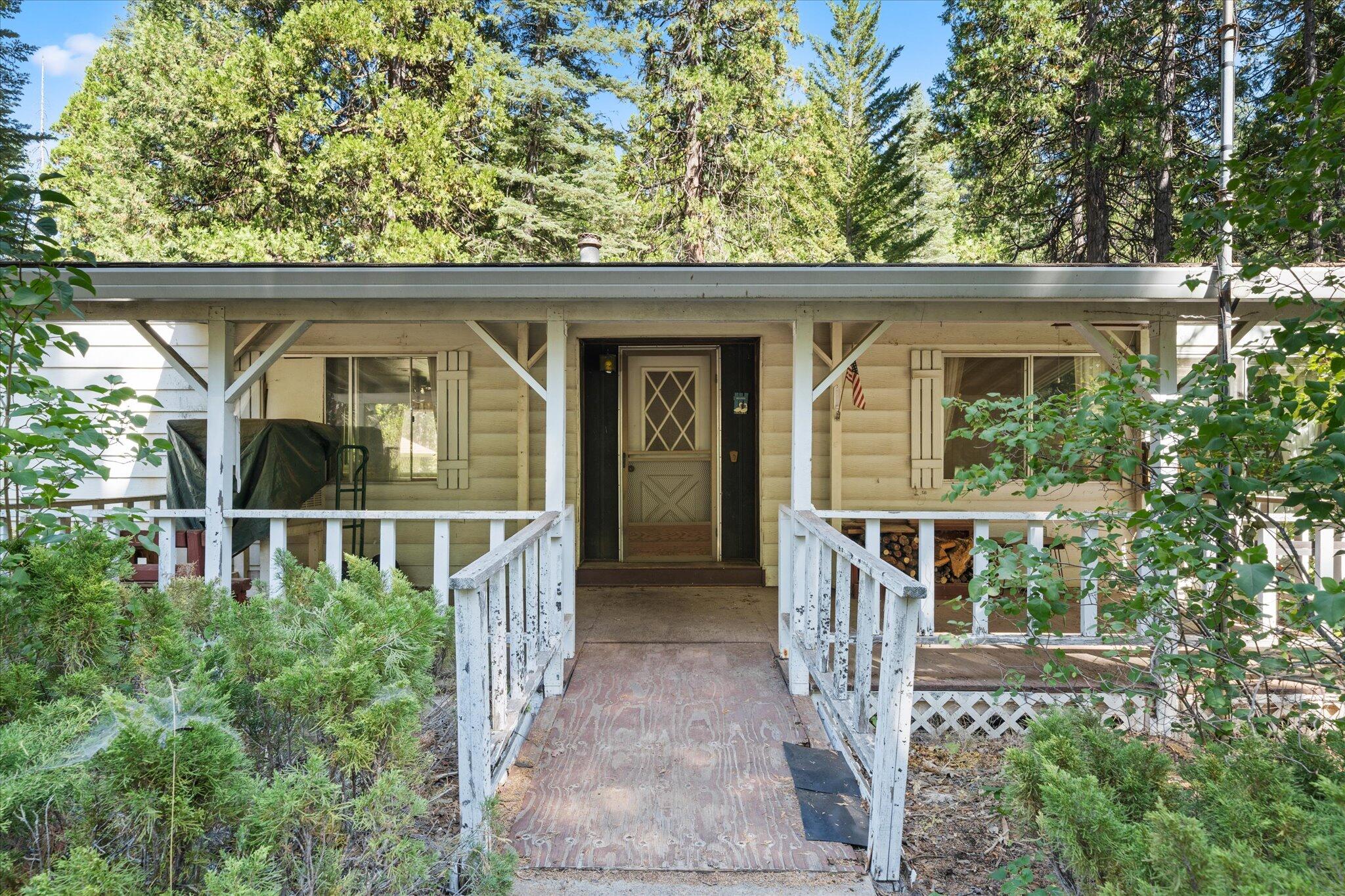 30588 Shingletown Ridge Road Shingletown, CA 96088 - Photo 2 of 44 front view of house with large windows and a yard with plants