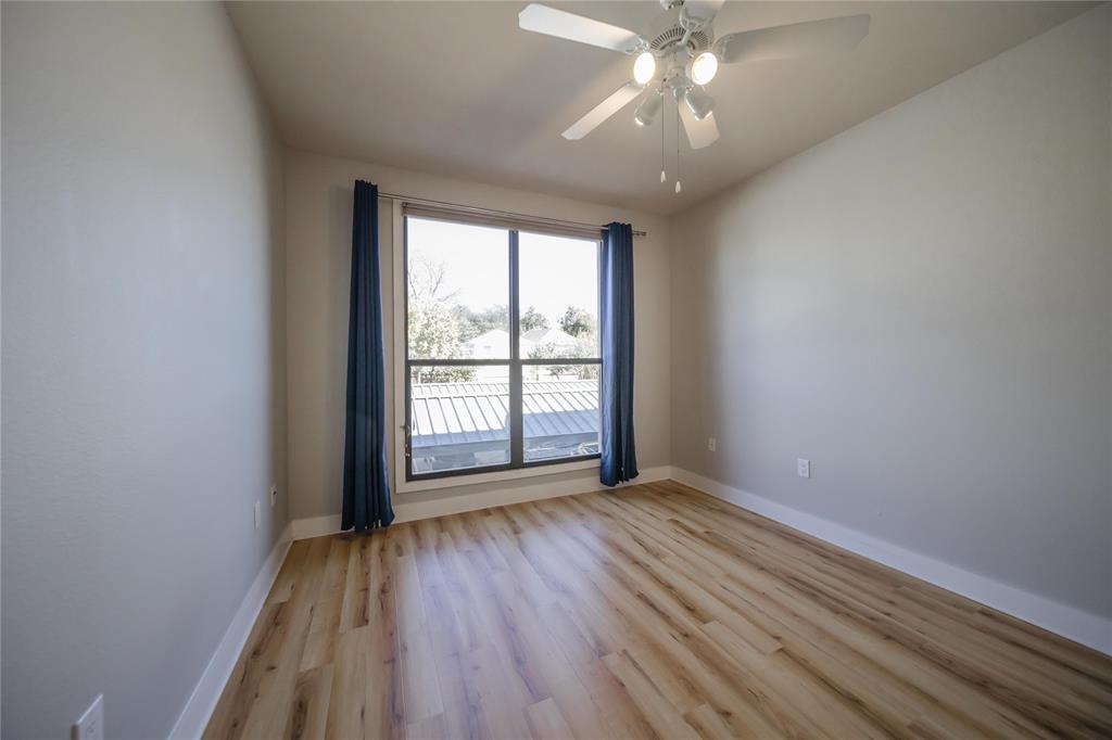 4414 Cedar Springs Road, Unit 214 Dallas, TX 75219 - Photo 16 of 29 Spare room featuring light wood-style flooring and ceiling fan
