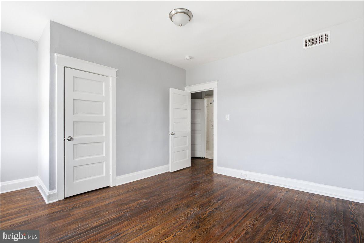 1231 North Potomac Street Baltimore, MD 21213 - Photo 13 of 25 a view of an empty room with wooden floor