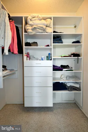 a refrigerator in a kitchen with stainless steel appliances wooden floor and cabinets