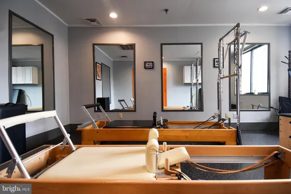 a room with gym equipment and a mirror
