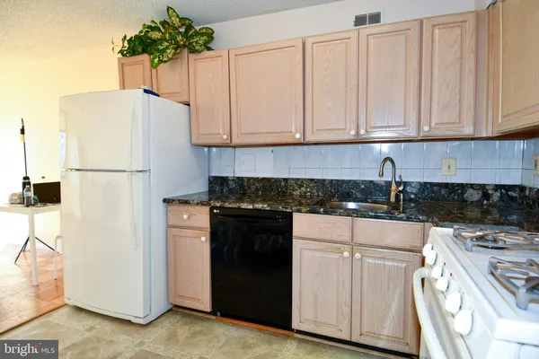 a kitchen with a white cabinets and white appliances
