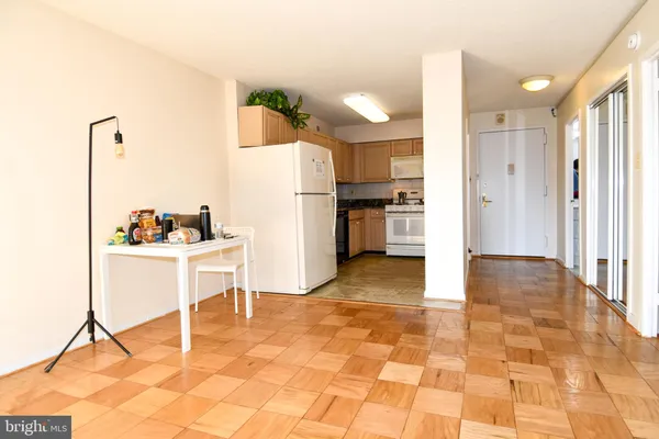 a view of kitchen with furniture and refrigerator