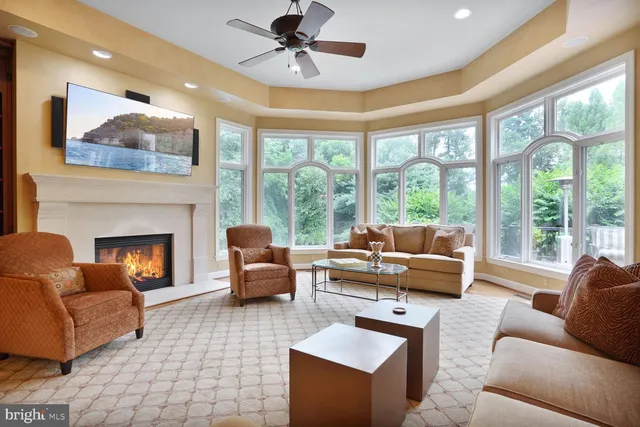 a kitchen with stainless steel appliances kitchen island granite countertop a refrigerator a stove a sink and a dining table with wooden floor