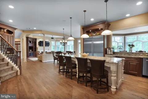 a kitchen with stainless steel appliances granite countertop a stove and cabinets