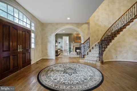 a view of a dining room with furniture a chandelier and wooden floor