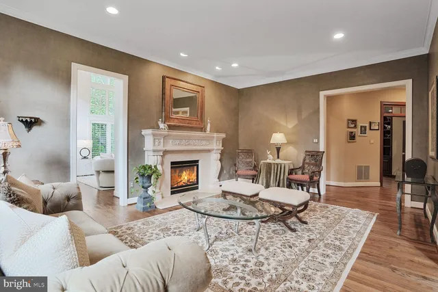 a living room with furniture and a kitchen view