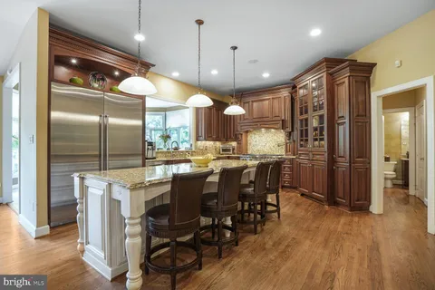 a bathroom with a granite countertop sink a large mirror and a shower