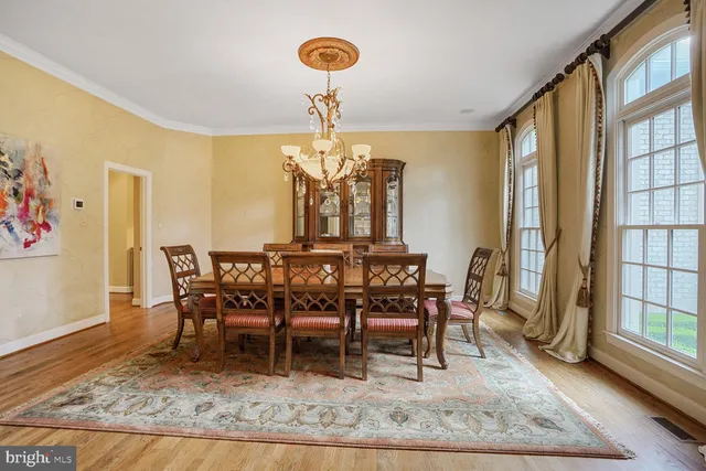a view of a dining room with furniture and a chandelier