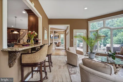 a front view of a house with a yard and trees