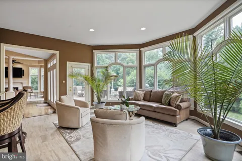a view of a house with backyard sitting area and swimming pool