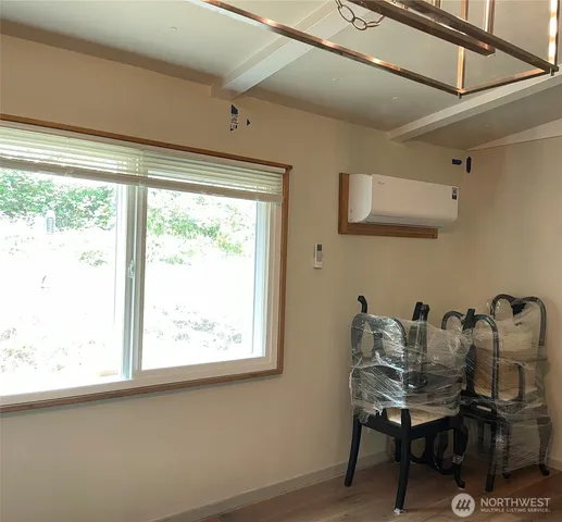 a view of a workspace with furniture and a window