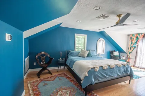 a bedroom with a bed and lamp