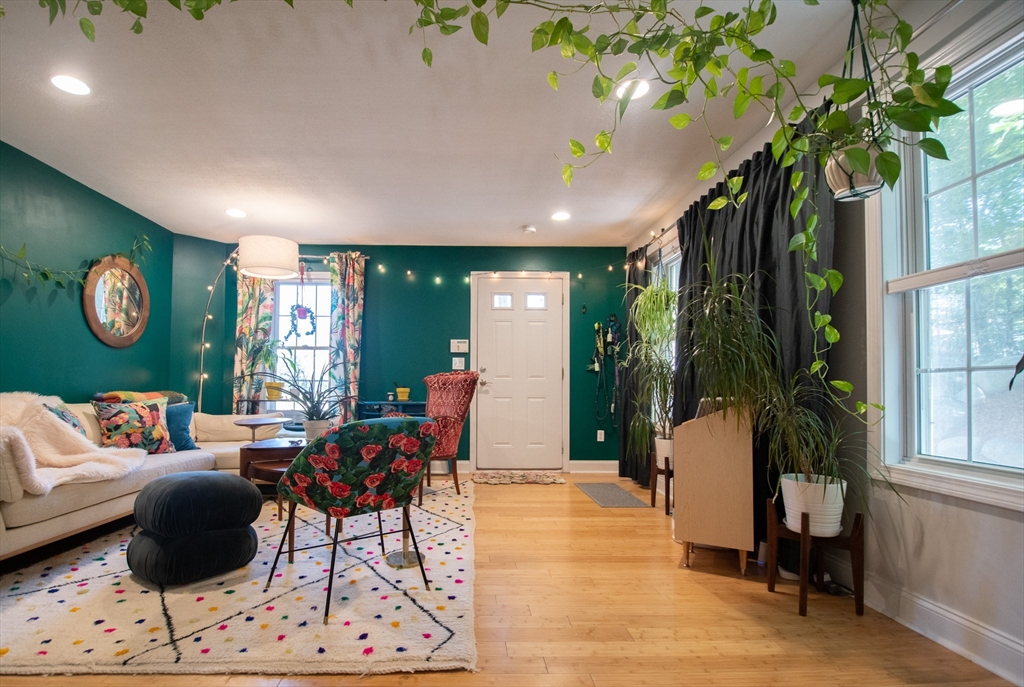 40 Brattle Street, Unit 7 Arlington, MA 02476 - Photo 3 of 15 a living room with furniture a potted plant and a large window