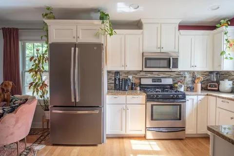 a kitchen with a refrigerator stove and microwave