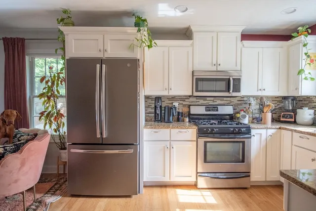 a kitchen with a refrigerator stove and microwave