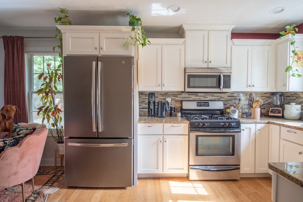 40 Brattle Street, Unit 7 Arlington, MA 02476 - Photo 5 of 15 a kitchen with a refrigerator stove and microwave