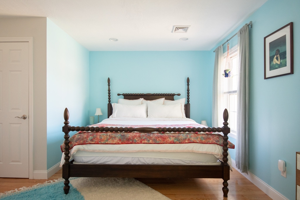 40 Brattle Street, Unit 7 Arlington, MA 02476 - Photo 7 of 15 a bed sitting in a bedroom next to a window