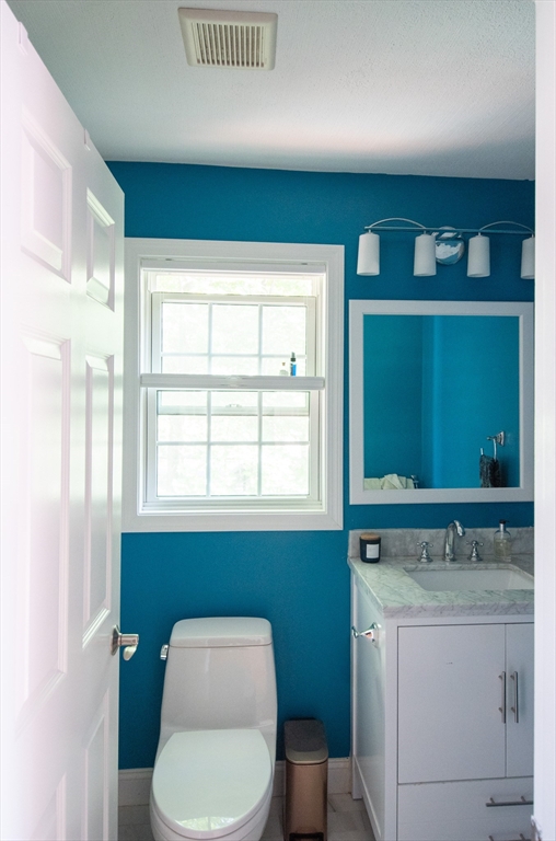 40 Brattle Street, Unit 7 Arlington, MA 02476 - Photo 9 of 15 a bathroom with a toilet sink and mirror
