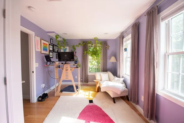 a bedroom with natural light and window