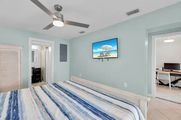 a bedroom with bed and a chandelier