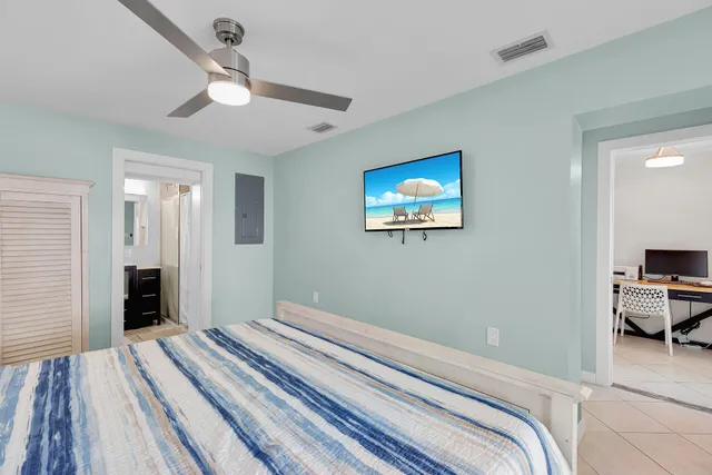 a bedroom with bed and a chandelier