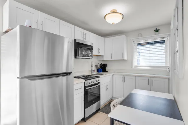 a kitchen with stainless steel appliances a refrigerator sink and cabinets