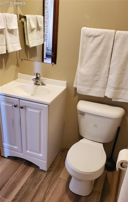 400 Victor Avenue Victor, CO 80860 - Photo 27 of 36 a bathroom with a toilet sink and mirror