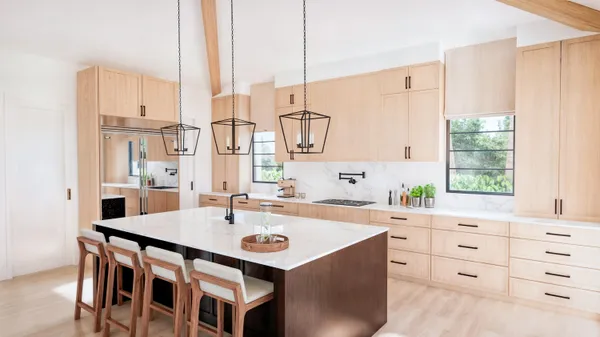 a kitchen with a sink a stove and white cabinets with wooden floor