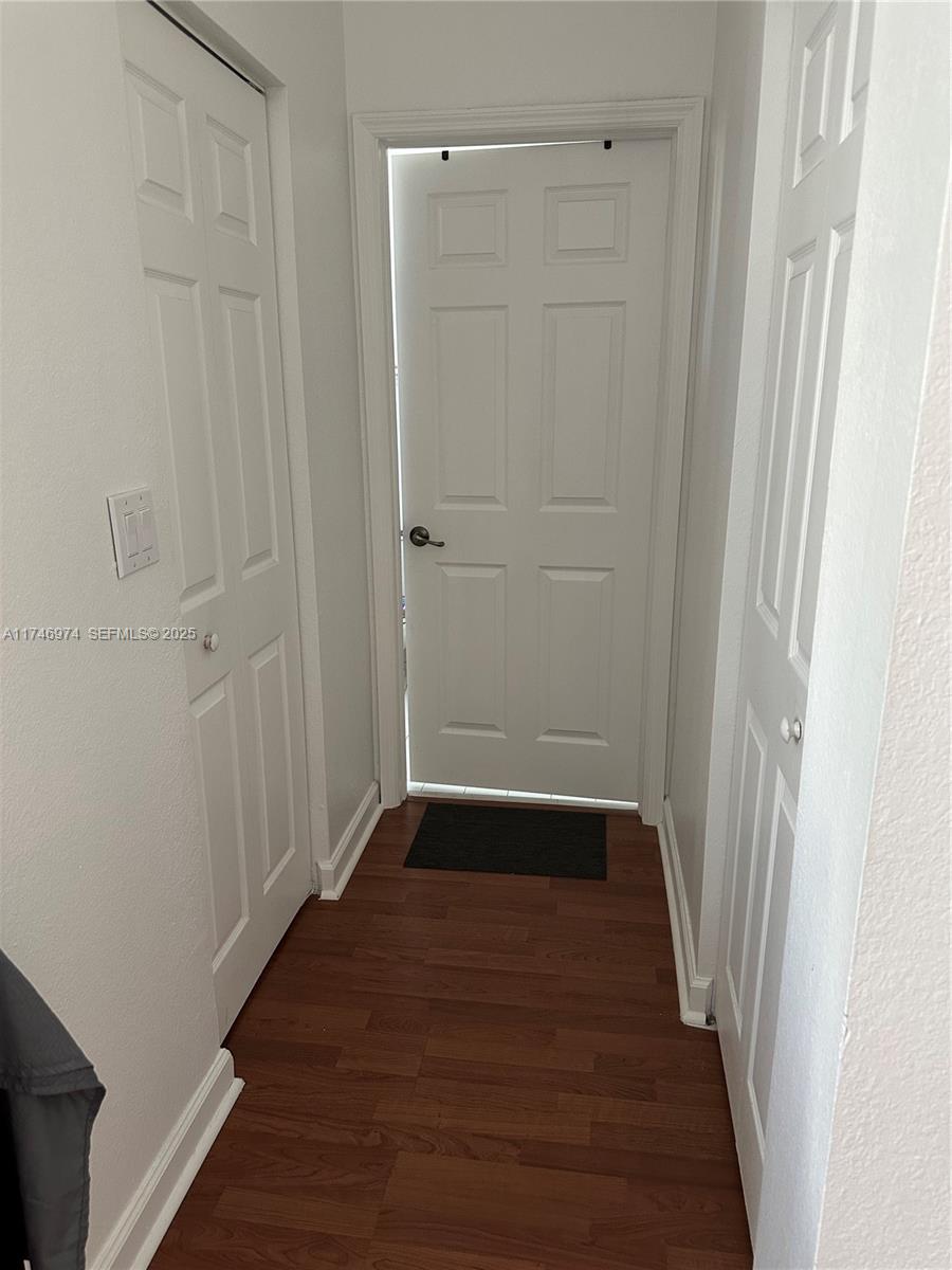11031 Southwest 246th Street Homestead, FL 33032 - Photo 21 of 25 a view of a hallway with wooden floor
