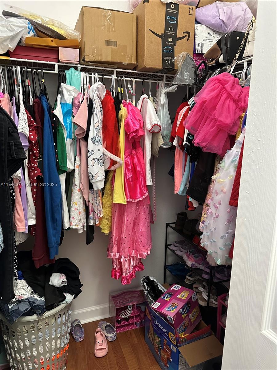 11031 Southwest 246th Street Homestead, FL 33032 - Photo 22 of 25 a view of walk in closet with clothes and shoes