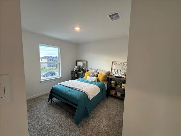 a bedroom with a bed and a night stand