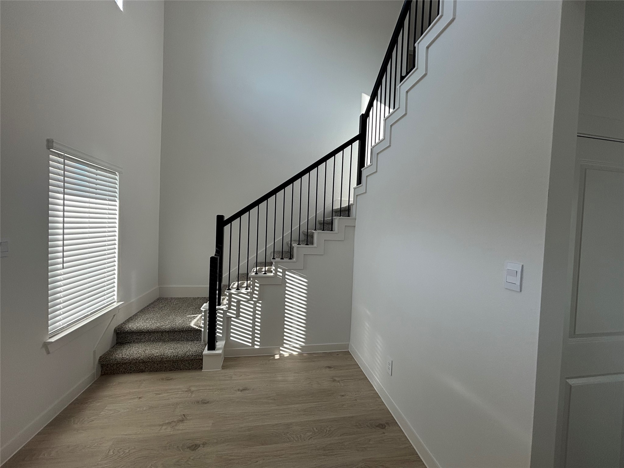 4315 Windsor Forest Fulshear, TX 77494 - Photo 4 of 50 The window in front of the staircase brings abundant natural light and the space in front of the staircase is appropriae to keep two chairs and a table.