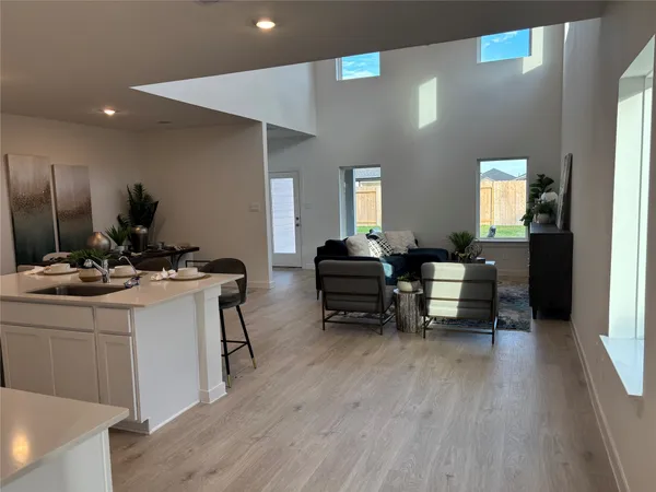 a kitchen with a dining table chairs and view living room