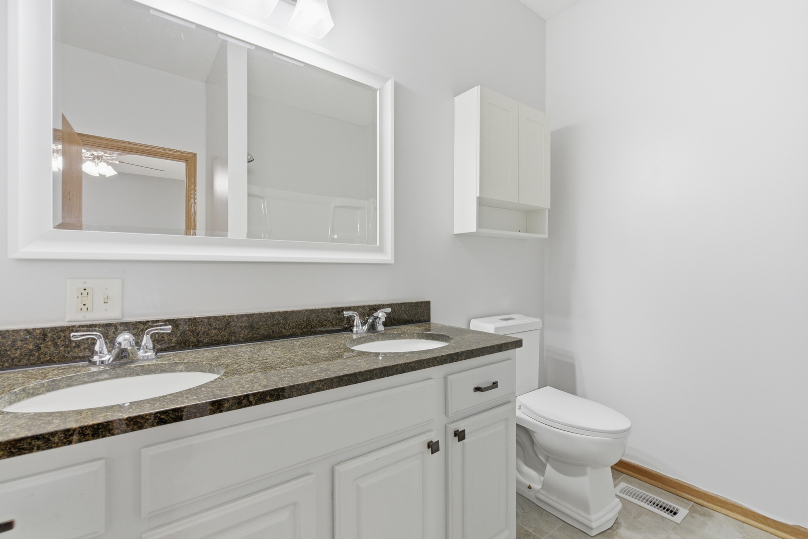 660 West 1st Street Braidwood, IL 60408 - Photo 12 of 19 a bathroom with a granite countertop toilet sink and mirror