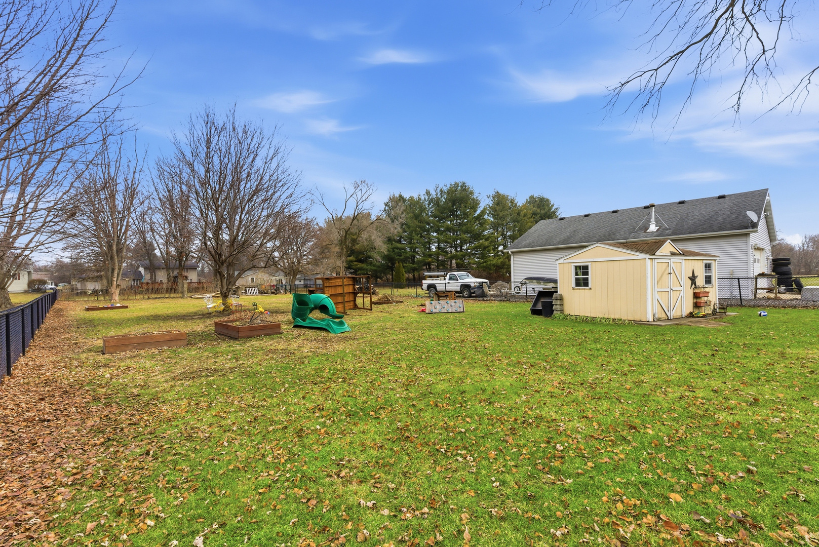 660 West 1st Street Braidwood, IL 60408 - Photo 18 of 19 a view of a white house with a big yard and large trees