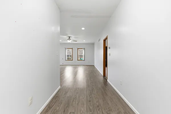 a view of hallway with wooden floor and staircase