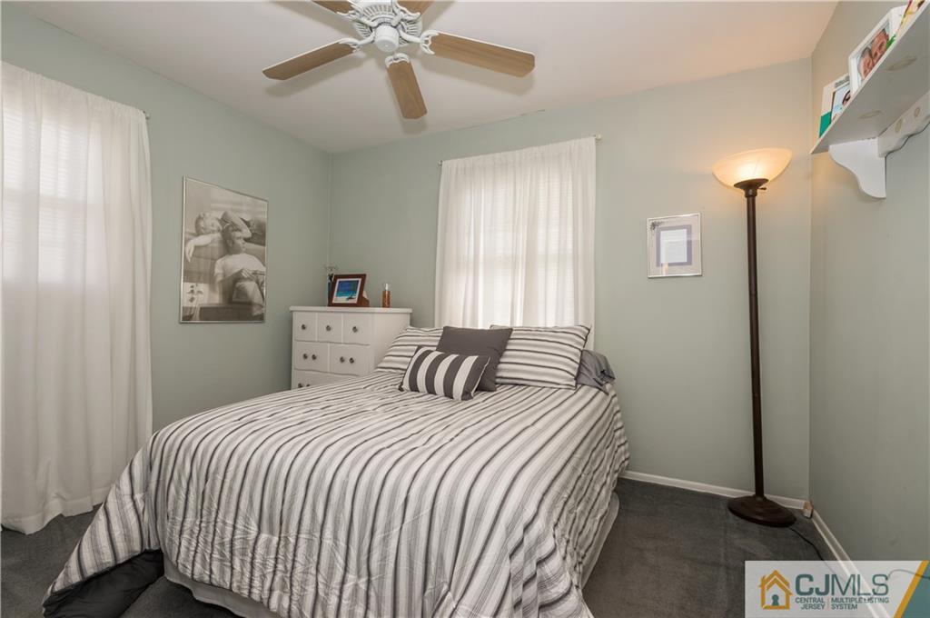 6 Paley Place Edison, NJ 08817 - Photo 11 of 18 a bedroom with a bed and a chandelier