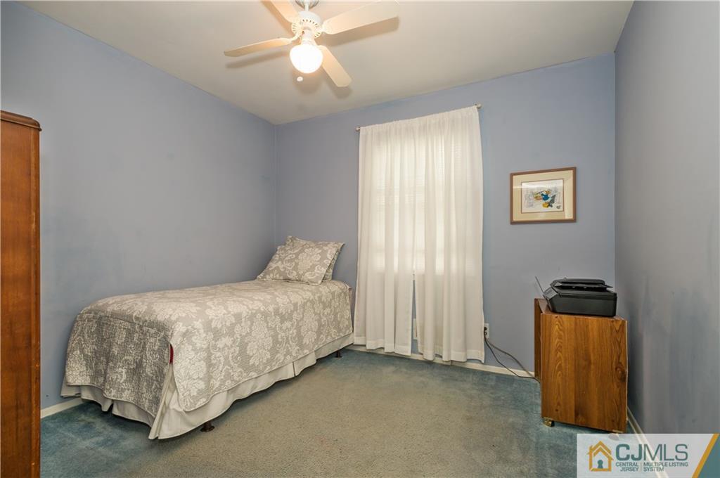 6 Paley Place Edison, NJ 08817 - Photo 12 of 18 a bedroom with a bed and a chandelier