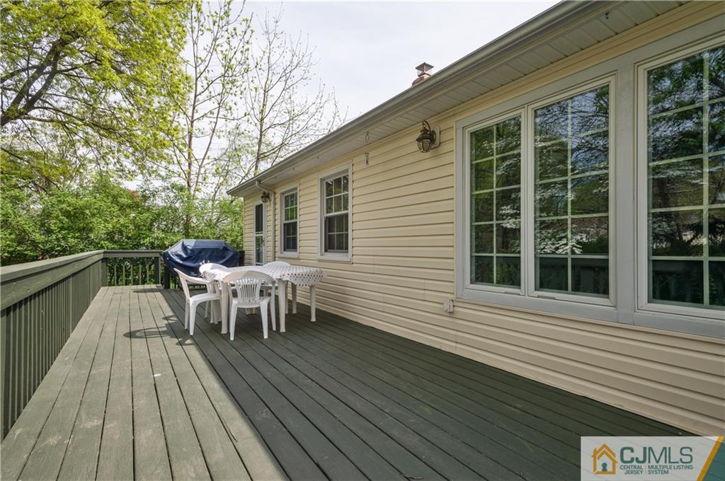 6 Paley Place Edison, NJ 08817 - Photo 16 of 18 a view of a roof deck with table and chairs and wooden floor
