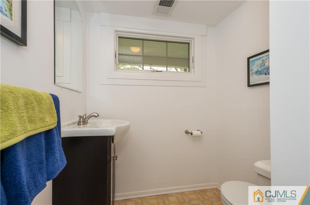 6 Paley Place Edison, NJ 08817 - Photo 3 of 18 a bathroom with a sink toilet and vanity