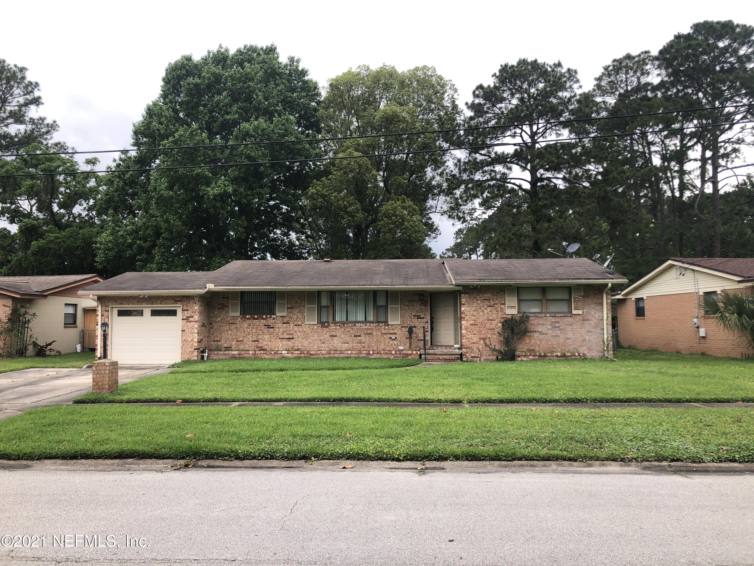 4126 Dayrl Road Jacksonville, FL 32207 - Photo 1 of 26 a front view of a house with a garden and trees