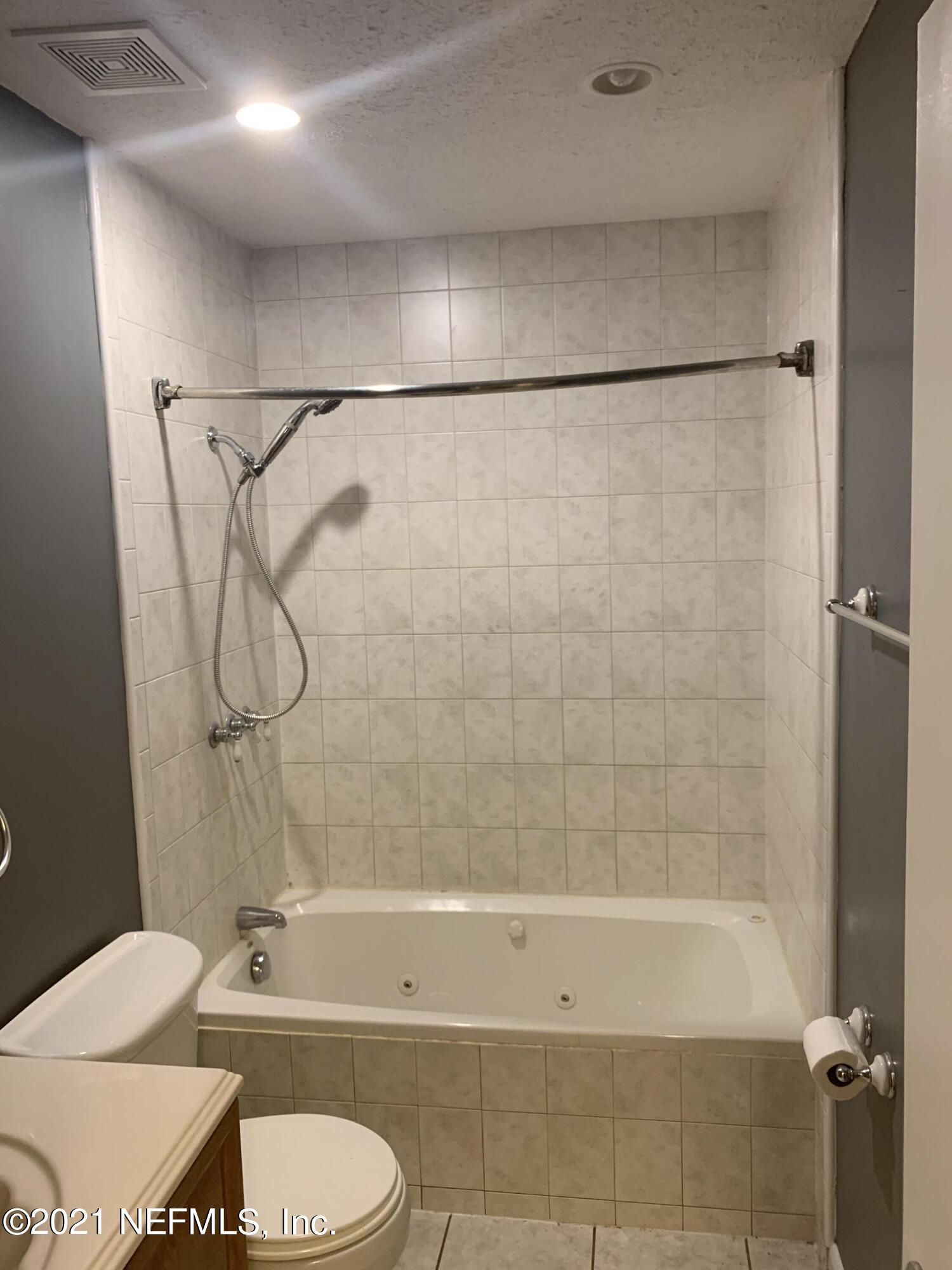 4126 Dayrl Road Jacksonville, FL 32207 - Photo 16 of 26 a bathroom with a bathtub toilet and shower